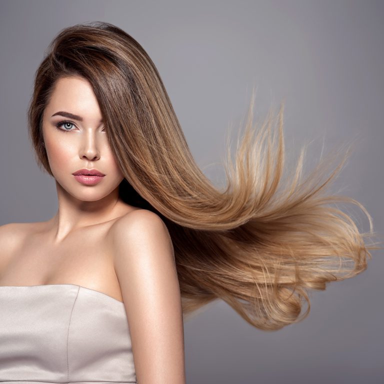 Young woman with long straight hair. Blond girl.